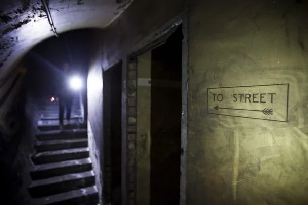 Passageway and upward staircase at Down Street disused station taken in 2015.

Photographer Toby Madden, London Transport Museum.