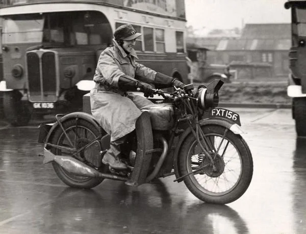 Woman motorcycle messenger, Miss Daisy Andrews, formerly an LT canteen assistant. Motorcycle messengers would courier messages to Down Street station to the back of the station through the "mews" under the third arch on the right in the previous phot