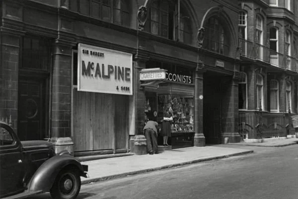 Down Street Station exterior in 1939, featuring Robert McAlpine Ltd. signage, a contractor, indicating works in progress at the already disused station.

Photographer unknown, London Transport Museum.