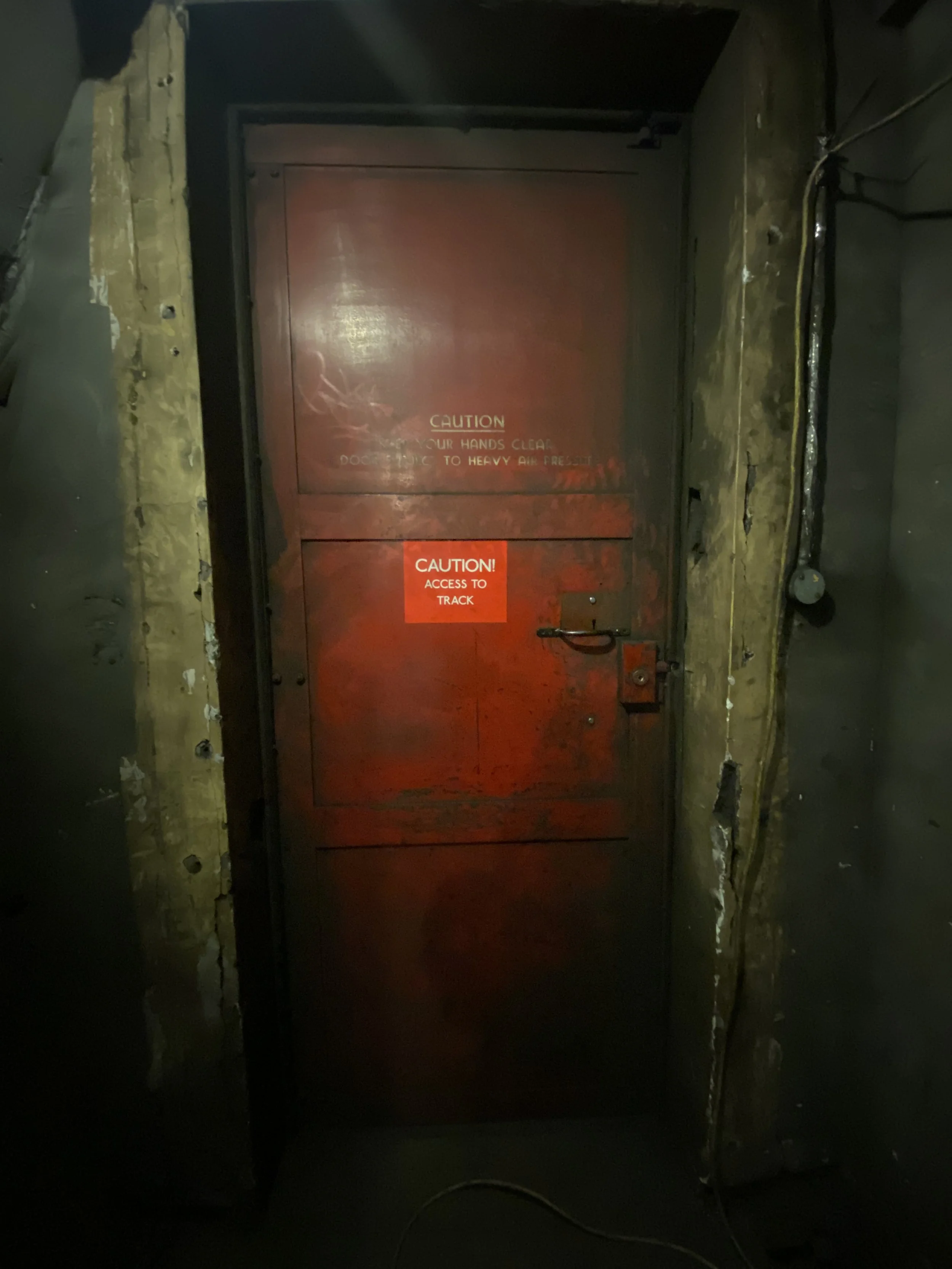 Heavy, presumably blast protected door, separating the telephone exchange area of the underground Railway Executive Committee headquarters from the disused platform for the Piccadilly Line in 2023.

Photographer Candace Leung.