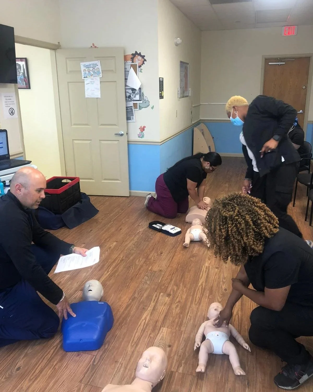 Students taking part in a mobile CPR training class