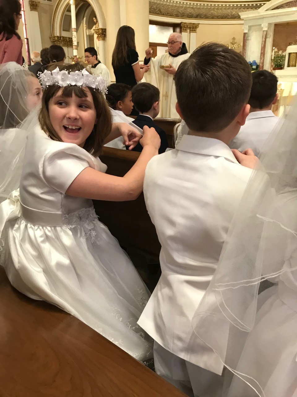 vivi 1st communion sudden recognition of me right behind her.jpg