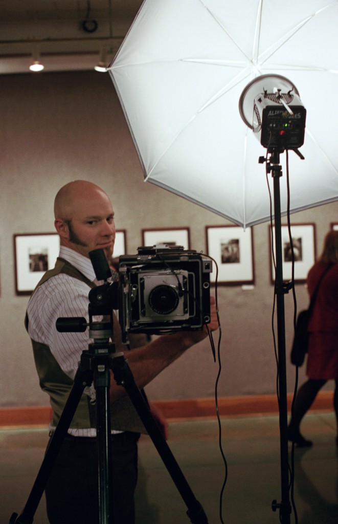Jason Kelley runs a 4×5 Graphic powered photo booth at Powell’s (Photo by Katt Janson)