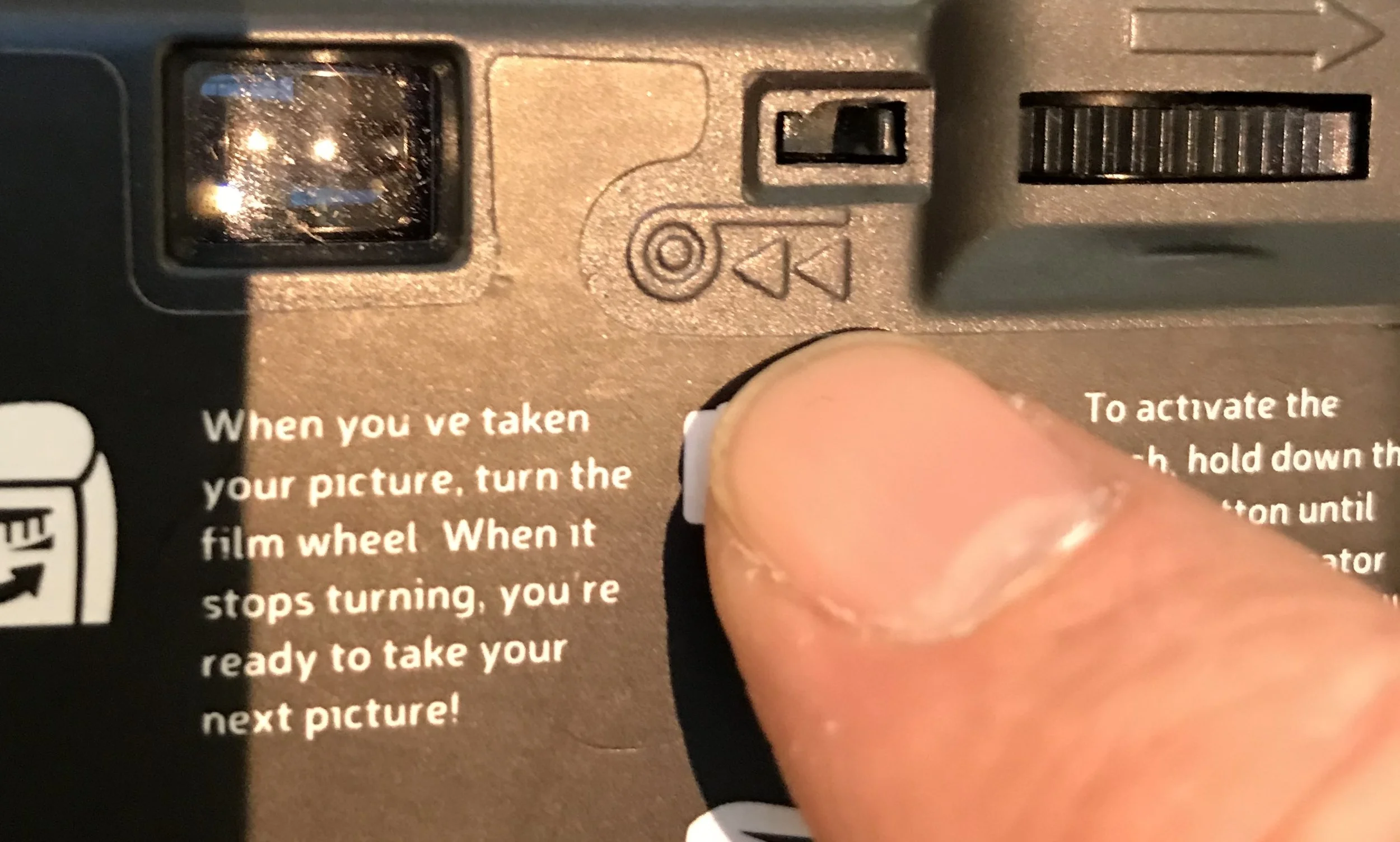 Be sure to switch the film release switch to the left position, (the switch is on the top right of the camera, just to the left of the film advance winder on the top right of the camera) which will disengage the film advance winder. (This is only temporary, until you have finished loading the film onto the left film spool.
