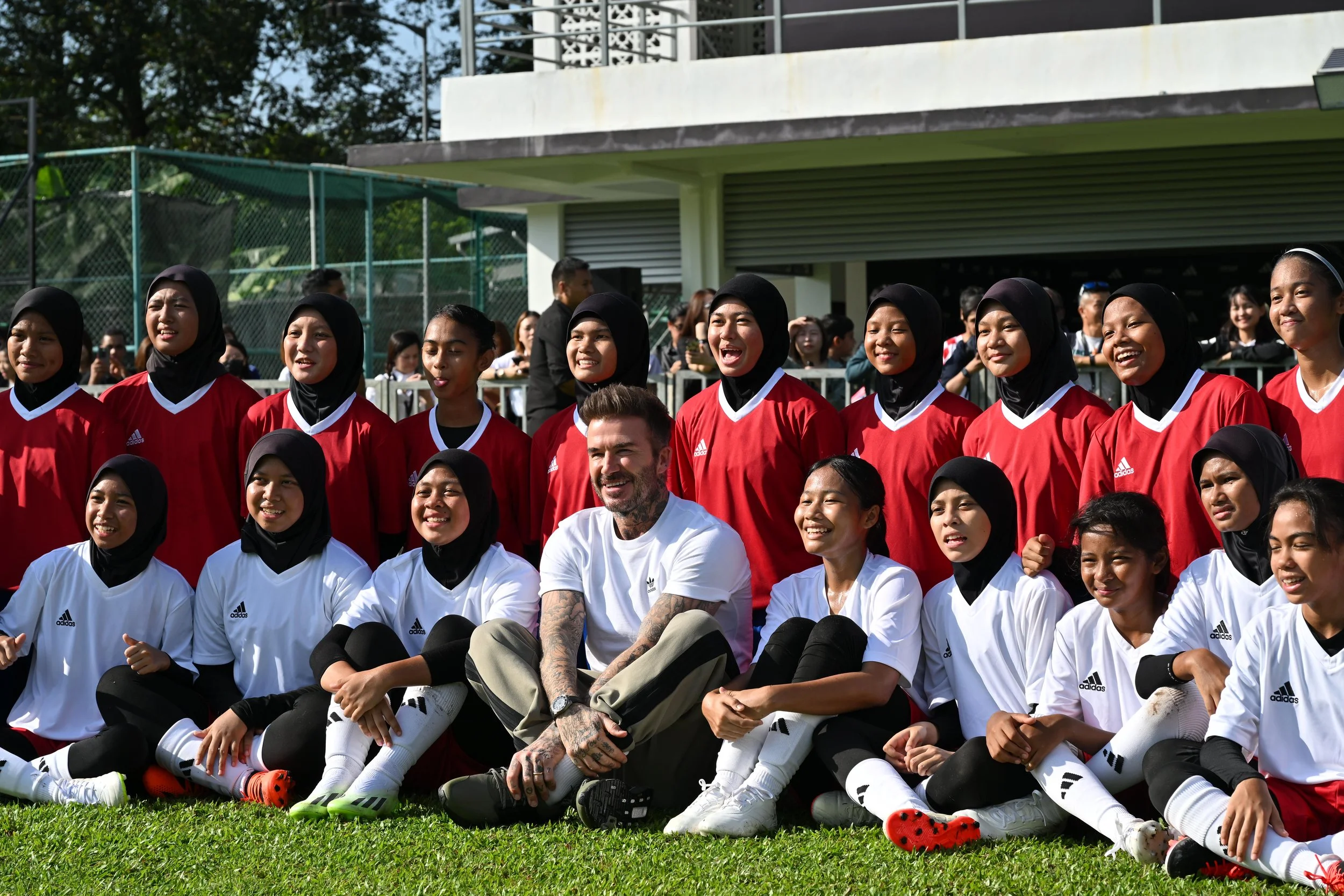 David Beckham joins the young female footballers for a group photo upon surprising the guests with his surprise visit at the launch of AMGFP 