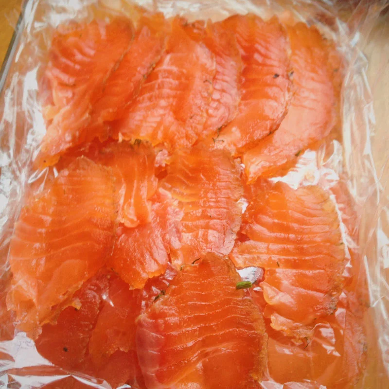 I absolutely love fish, I could live on it for every meal without getting sick of it. I know it is definitely a food grouping that most people can’t handle much of, but I can’t get enough! Even though it may be an illusion at times, I always feel really nourished when I eat seafood. Whether I am wolfing down pounds of crab legs with lemon juice or going down the more healthful route of savoring sashimi with fresh ginger, I always enjoy the fresh flavors of seafood. Unfortunately, my wallet does not appreciate my expensive taste. One of the meals that I have always enjoyed is a breakfast of smoked, pickled or cured fish. For those that are less adventurous, I will hold off on my extolment of herring in cream sauce and instead touch upon a more commonly accepted dish- Gravlax. Gravlax is salmon that is lightly cured with salt, sugar, fresh herbs, spices and other additions if inspiration strikes. I rarely order Gravlax or even buy it from the grocery store because it is so expensive for the amount, so I have grown accustomed to this being a special treat. Not anymore, why buy a four-ounce container for gold dust when you can inexpensively and easily make your own at home! I know it may sound very ambitious, but trust me, the benefits of making your own Gravlax far outweigh perceived hassle of doing so. The procedure goes as follows: Buy salmon. Get the highest quality product available. While this fish is going to be cured and thus preserved, it is still raw. There is not an unlimited shelf life to this dish so it should be consumed within a few days of completing the process. Rinse the fish and dry it. Next, line a rimmed dish with plastic wrap. Whatever you choose to put the fish in, be aware that liquid will accumulate so thee dish should have sides. Now, create your cure. Sugar and salt are mandatory, I like to use a two to one brown sugar to salt ratio. Dill is also mandatory for Gravlax, use a few big bunches. Other additions can and should include peppercorns and coriander. If you so desire, other herbs or spices such as juniper berries or fennel seeds, or citrus zests will elevate the dish even more. Many people choose to add a few drops of liquor, such as vodka. Take some of the cure and line the bottom of the dish, then rub half of the mixture on the fish. Place the fish skin side down and cover it with the remains of the cure. Wrap the fish entirely in plastic wrap and place in the fridge with something heavy on top. In my own NYC apartment experimentations, I placed a second baking dish on top of the salmon and then topped it with a housewarming six pack we had recently received. Every twelve hours, flip the fish. Liquid will be drawn out from the combination of weight and salt on the fish, this is the point of curing. In two to three days, remove the fish, rinse and dry again, then thinly slice to serve. I recently attempted this project as a farewell meal when finishing up an internship and was ecstatic with the results! I recommend for all to try at one point in their lives, it’s delicious, economical, and very impressive for guests. Give yourself a pat on the back and enjoy those omega threes flowing through your veins.