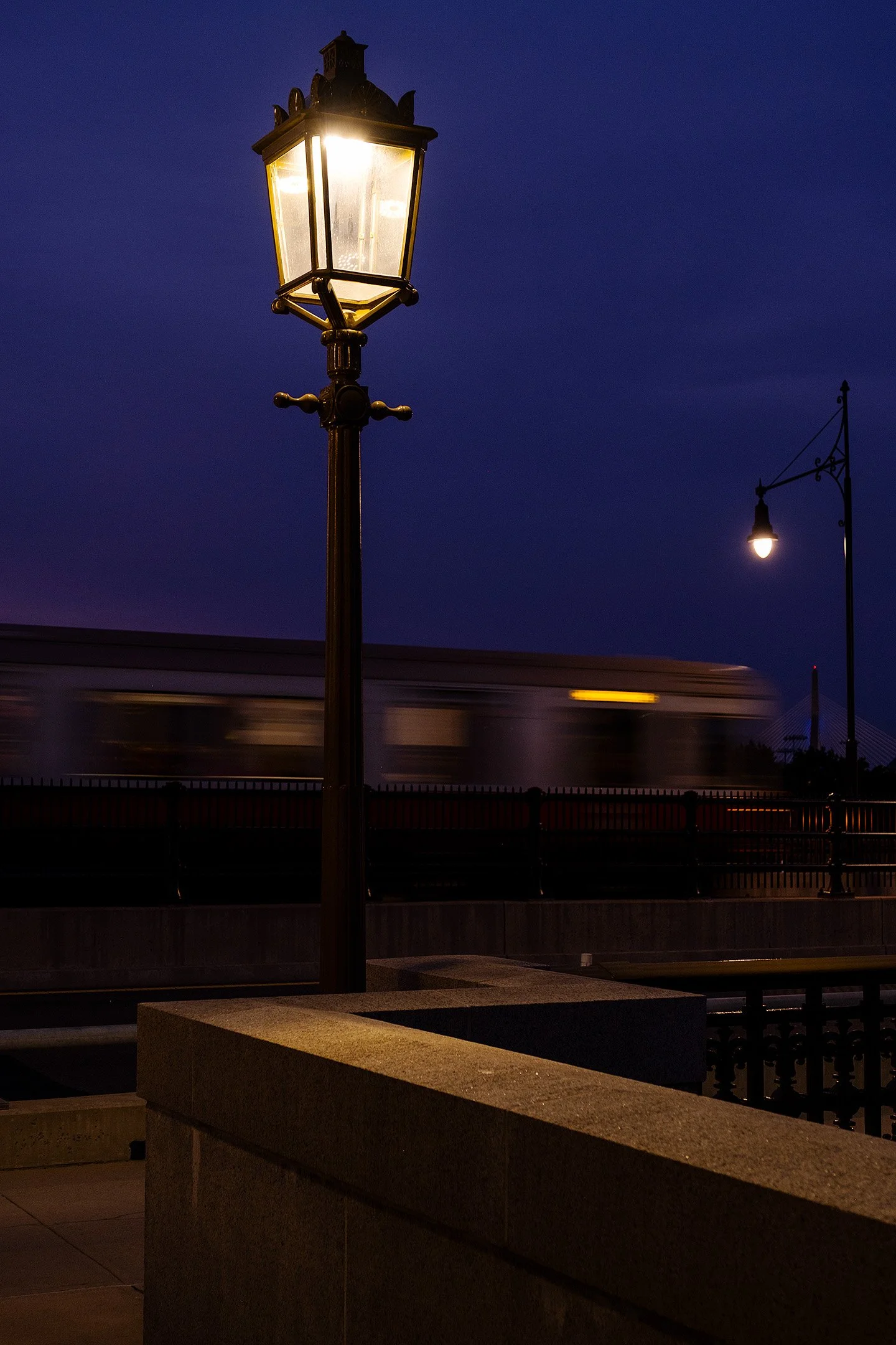  A Red line train crosses the Longfellow bridge at dusk. 