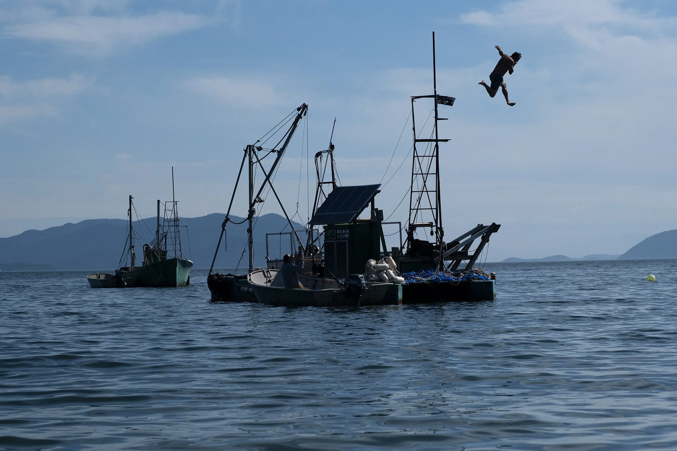 After helping launch the gear, crew member Sully jumps from the tower into the waters of Legoe Bay.