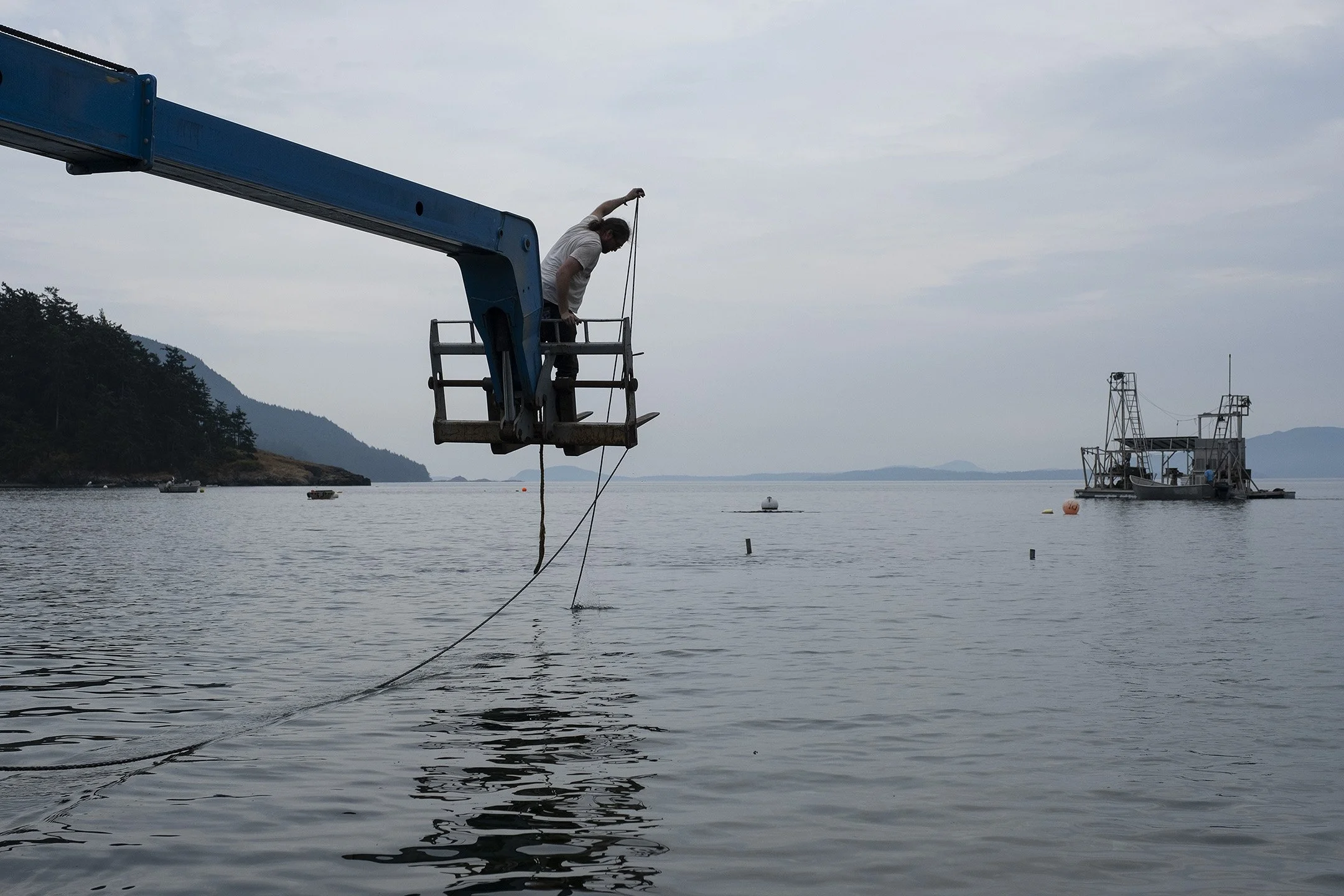 A crew member works to retrieve the cart that launched the reefnet gear into the water.