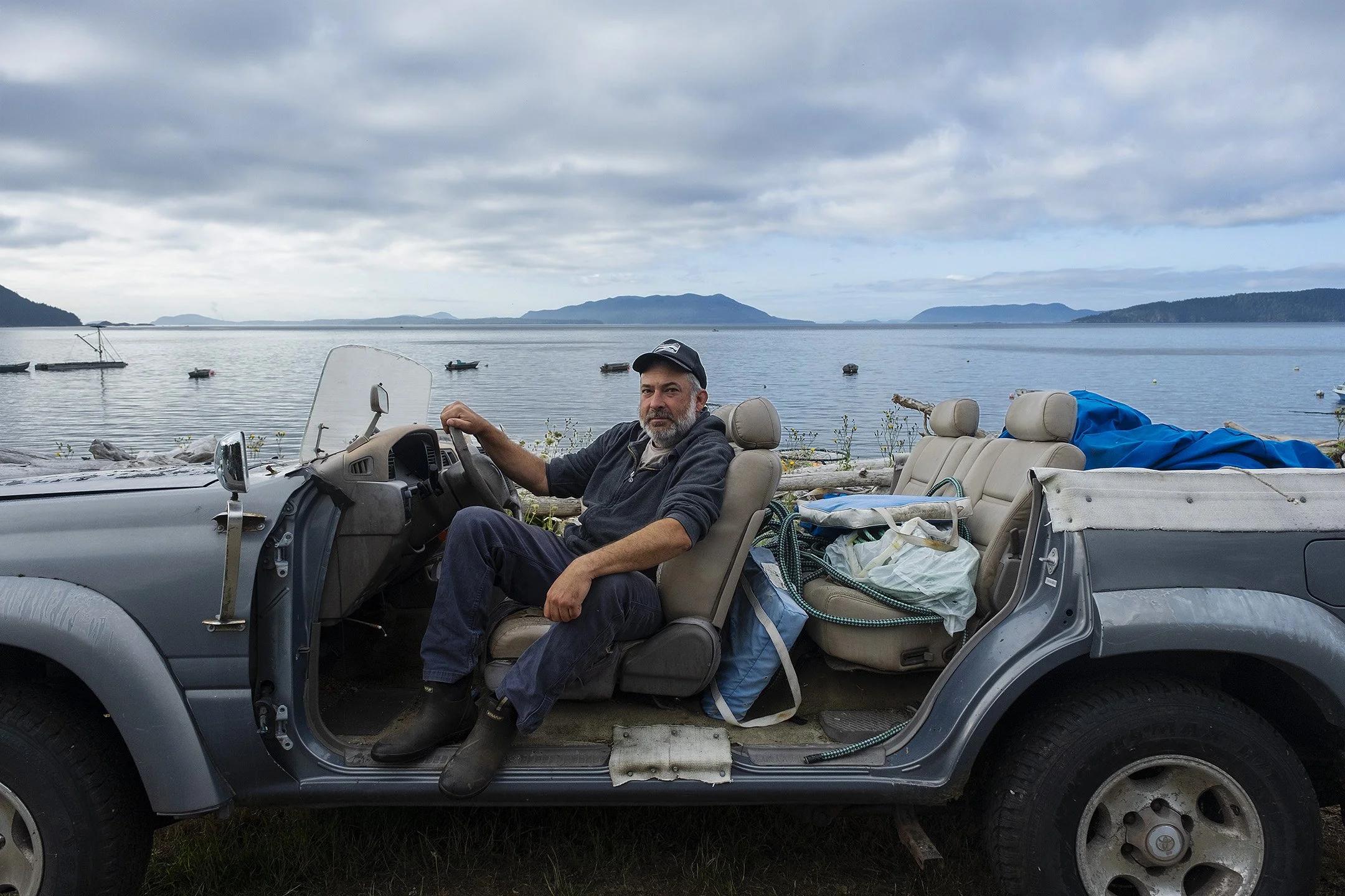 Simon, one of the reefnet fisherman, sits in his converted Land Cruiser on Legoe Bay.