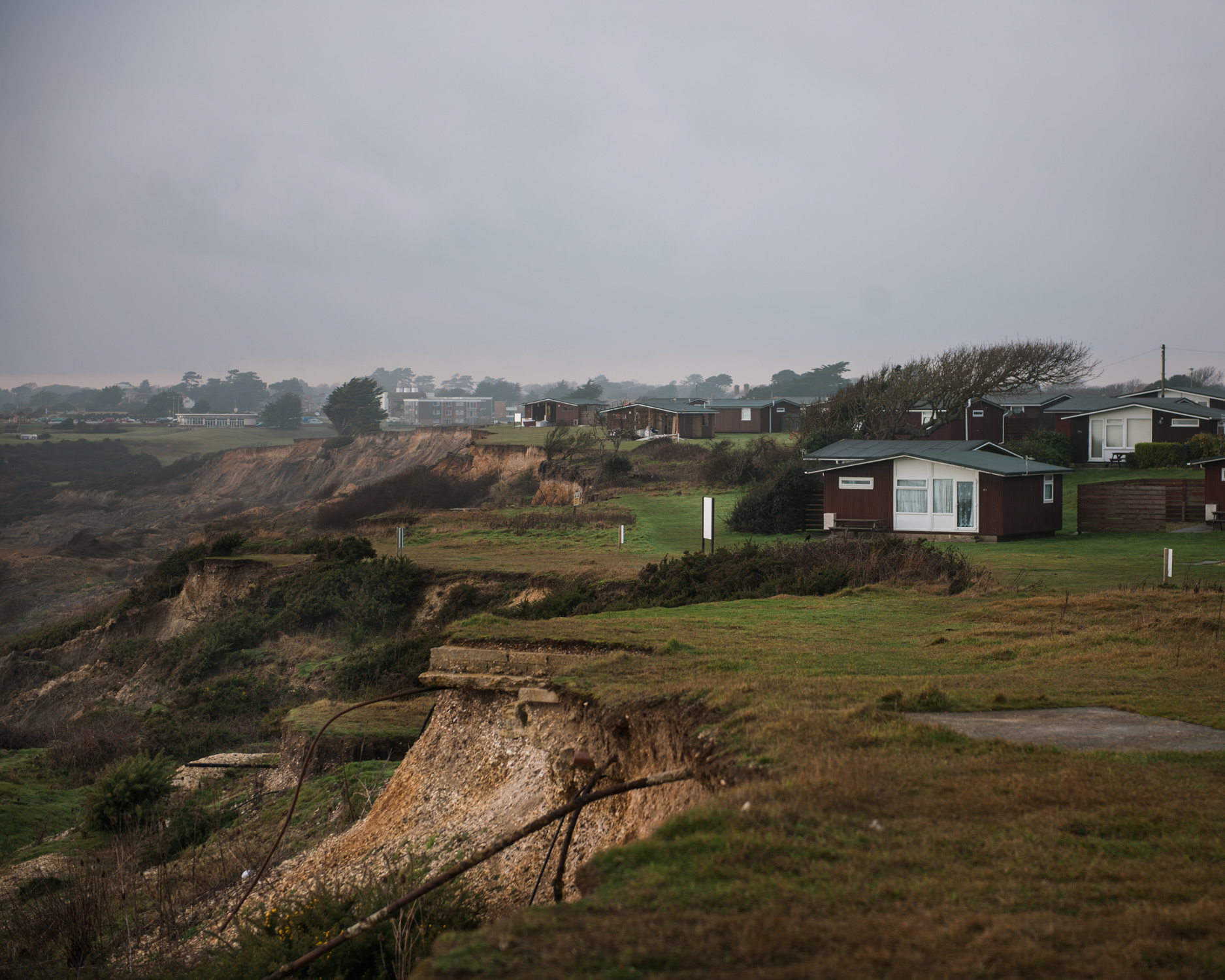 A holiday home park is battered by the prevailing easterly wind in West Sussex. The park has already had to move a significant amount of the homes back from the edge of the cliff.