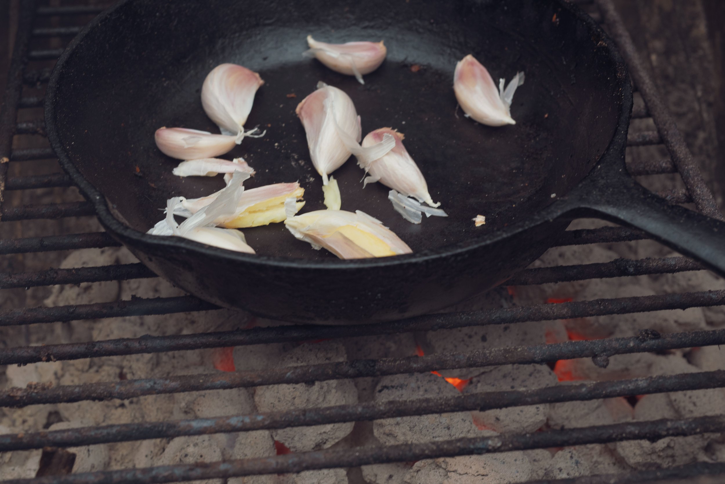 Similar to the traditional Mexican technique of roasted garlic in a comal for salsa, roasting garlic in a pan mellows and sweetens the garlic.. and your breath!