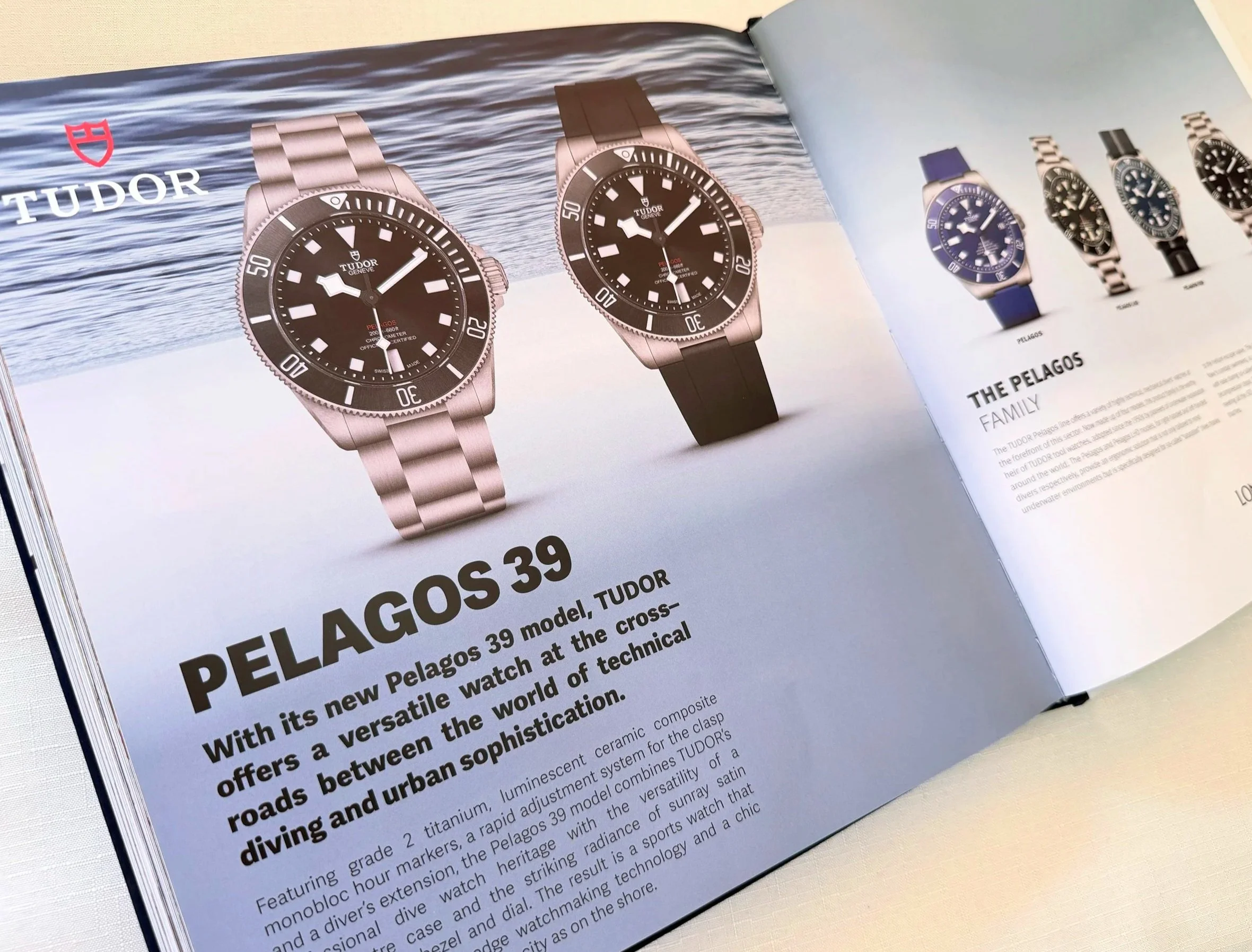 Open book or catalog showcasing a collection of Tudor Pelagos watches with a background of water and waves.