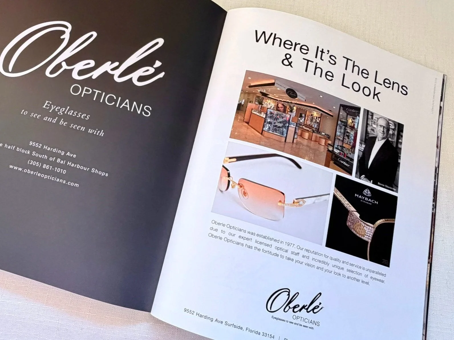 An open magazine showing advertisements for Oberlé Opticians and various eyewear products, including sunglasses and eyeglasses, along with images of the store interior and a photo of Bernie Oberlé.