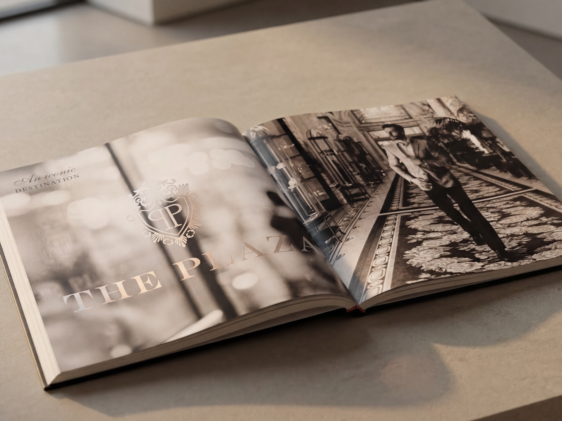 Open magazine displaying a black and white photograph of a woman walking on an ornate patterned floor inside a grand building with intricate architecture.