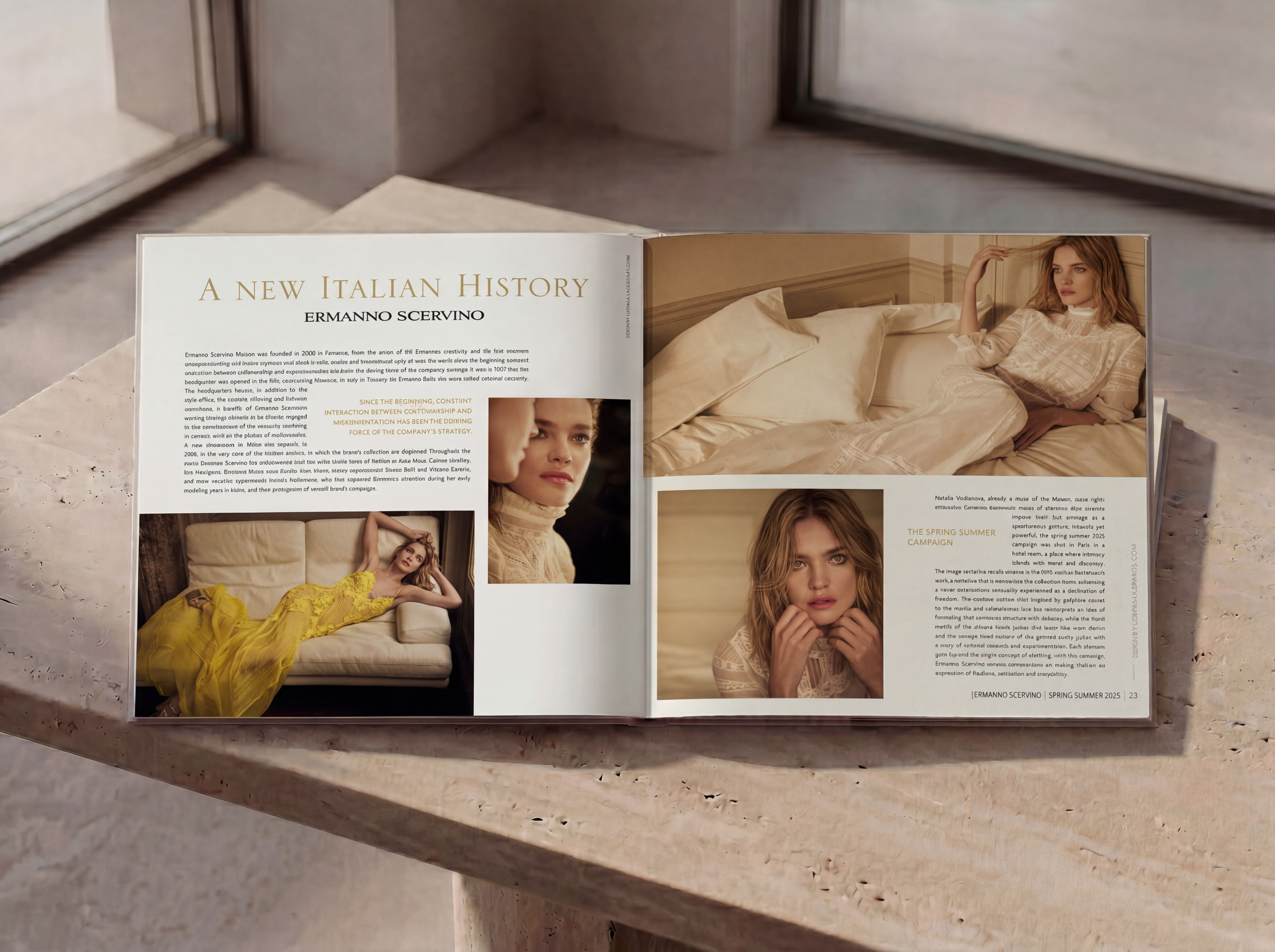 Open book on a marble surface; pages feature images of a woman in beige clothing lying on a bed and sitting against a beige wall, with text titled 'A New Italian History' and 'Ermanno Scervino,' and images of the woman in various poses.
