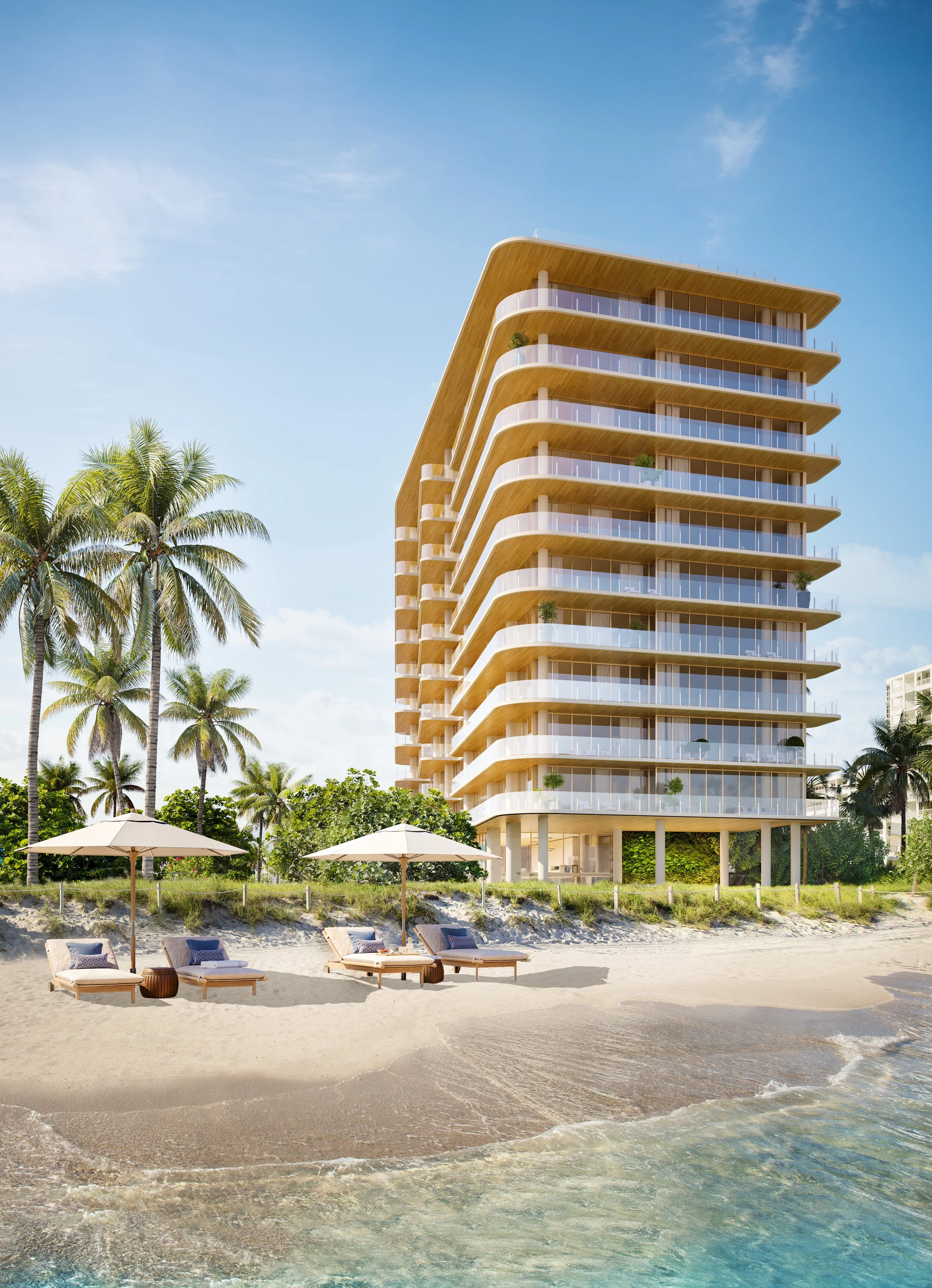 Modern beachfront hotel with curved balconies, surrounded by palm trees, with lounge chairs and umbrellas on sandy beach in front, under blue sky.