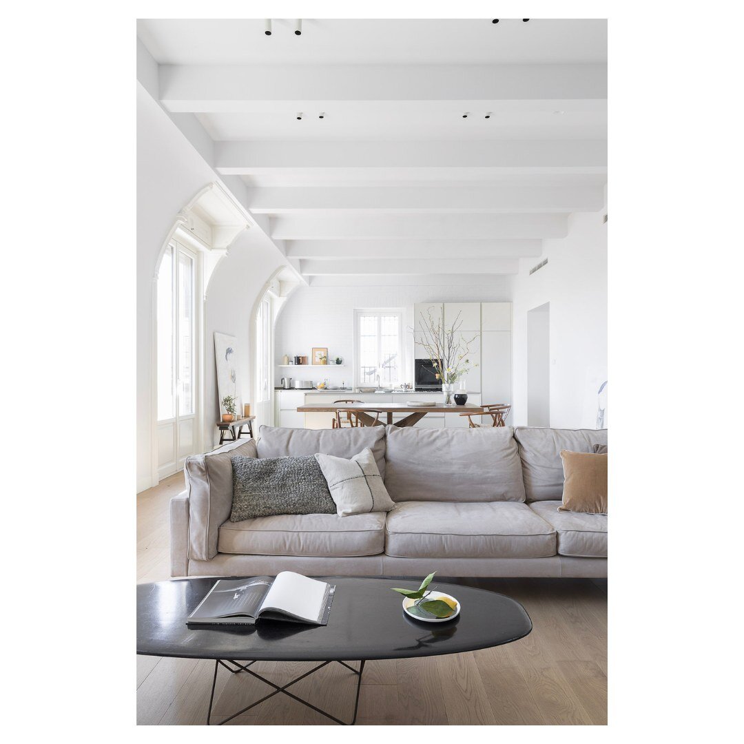 frontal view of open floor plan social space. We refinished the beautiful curved walls and french windows that make for this unique space. Not to mention, the purchase of a luxe sofa by B&amp;B Italia

#luxuryinteriordesigns #interiordesignitaly #int