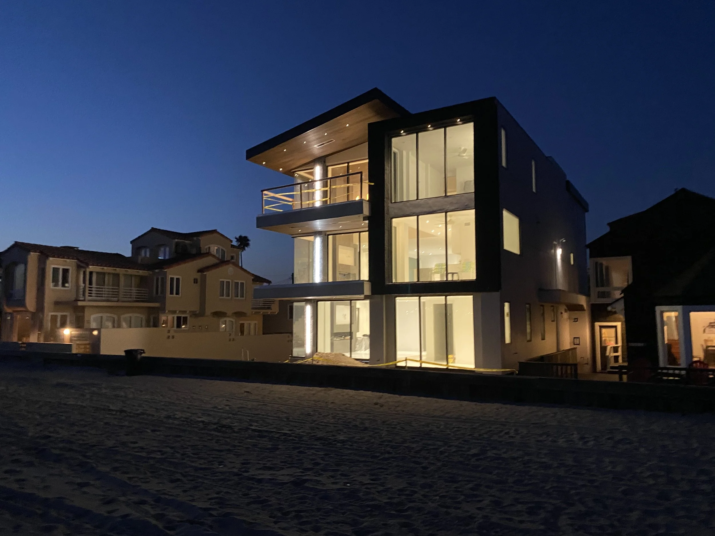 Beachfront new construction home in Long Beach at dusk