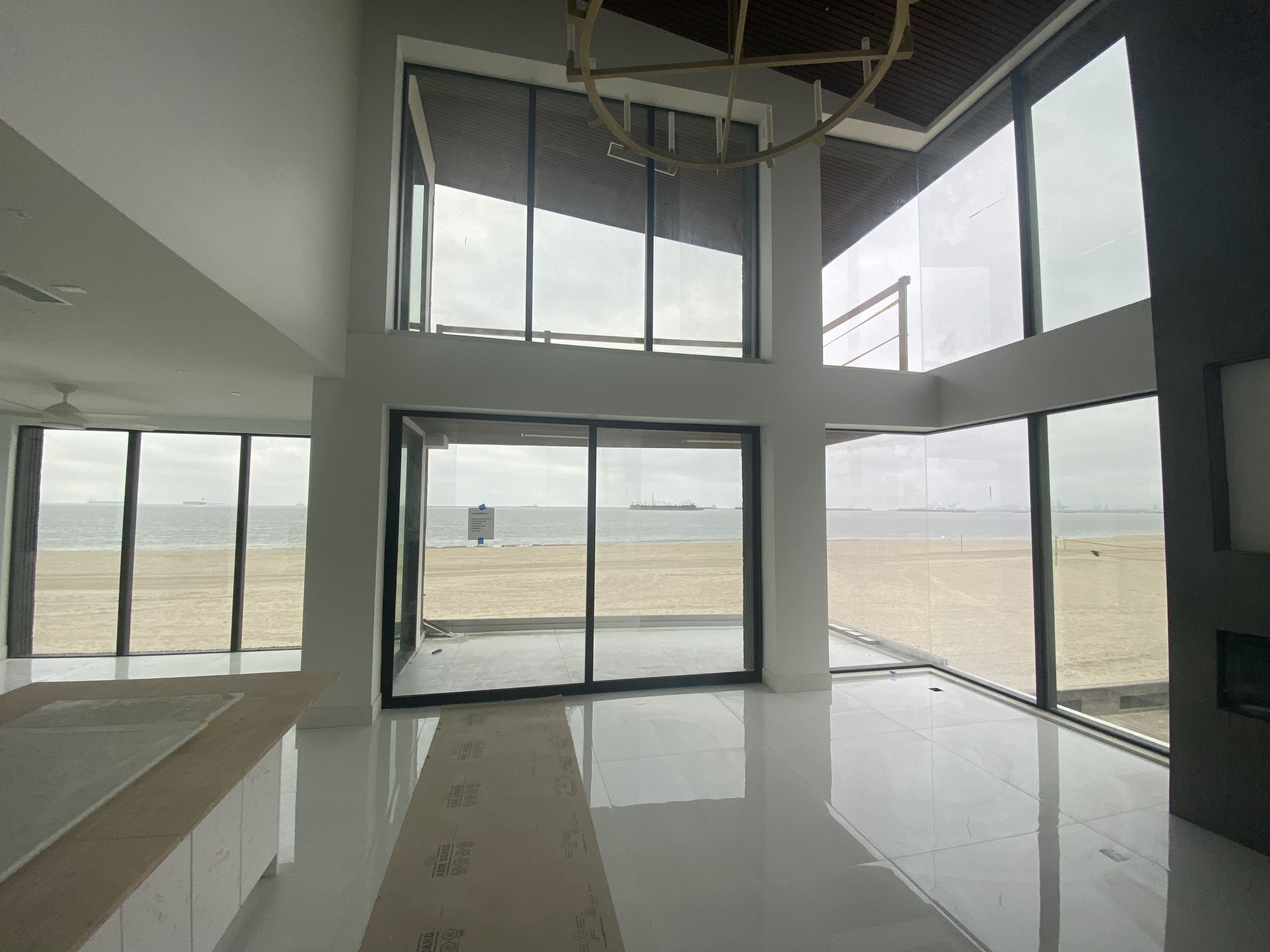 Floor-to-ceiling ocean-view windows in new construction home
