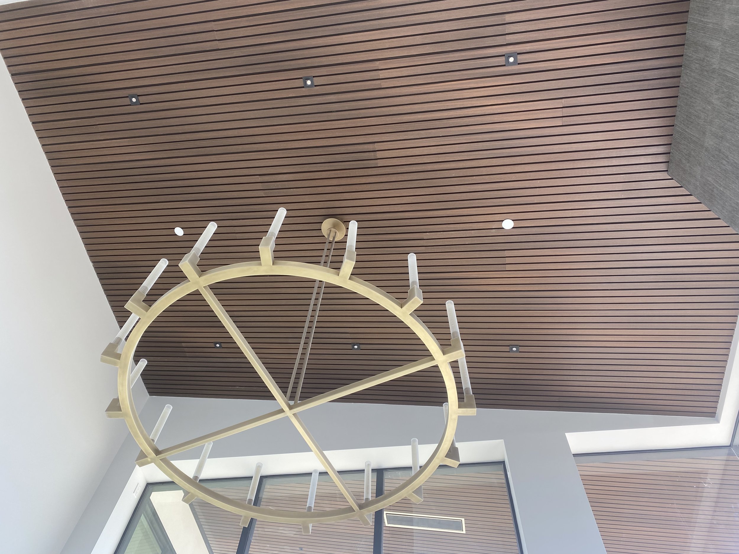 Wood slat ceiling with ring chandelier