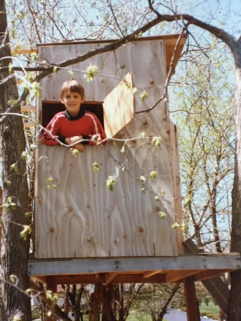 Craig in his childhood treehouse that he helped design and build.