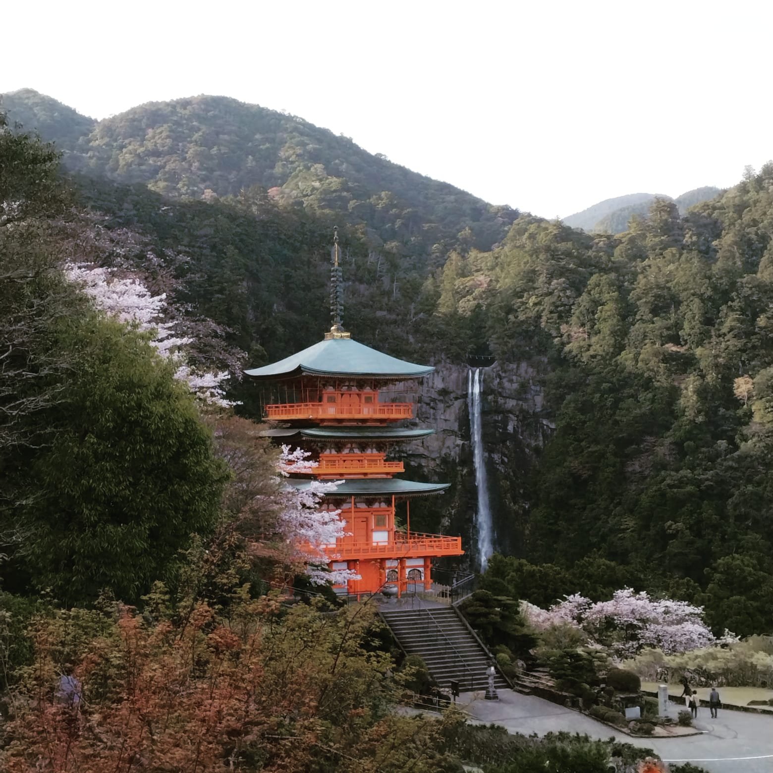 The iconic Seiganto-ji pagoda and Nachi Falls on the Kumano Kodo, a sacred highlight of Ashram’s Japan hiking retreat.