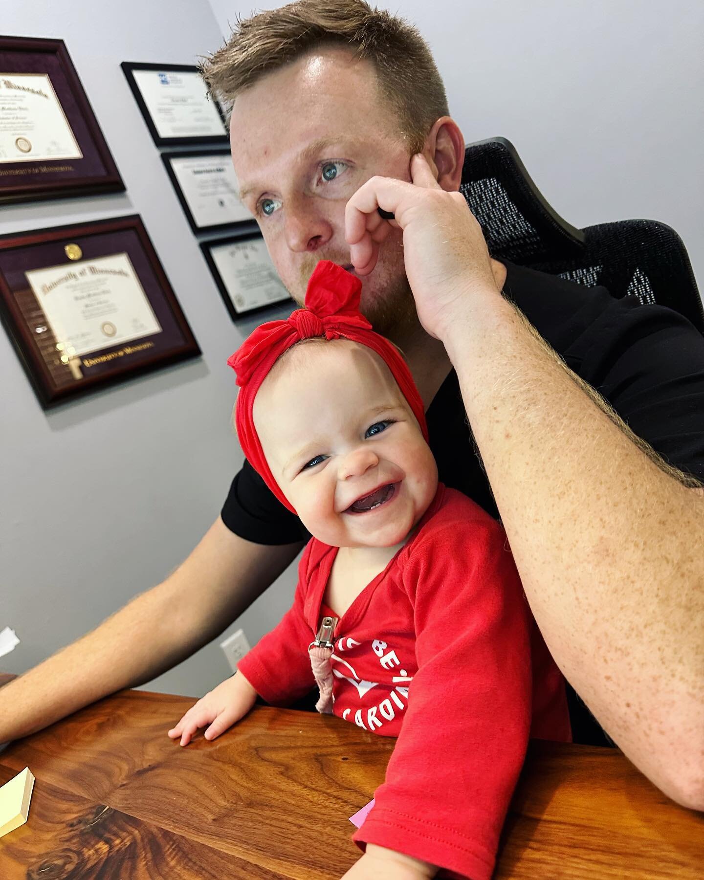 Is Quinn helping daddy with paperwork? Or distracting daddy?