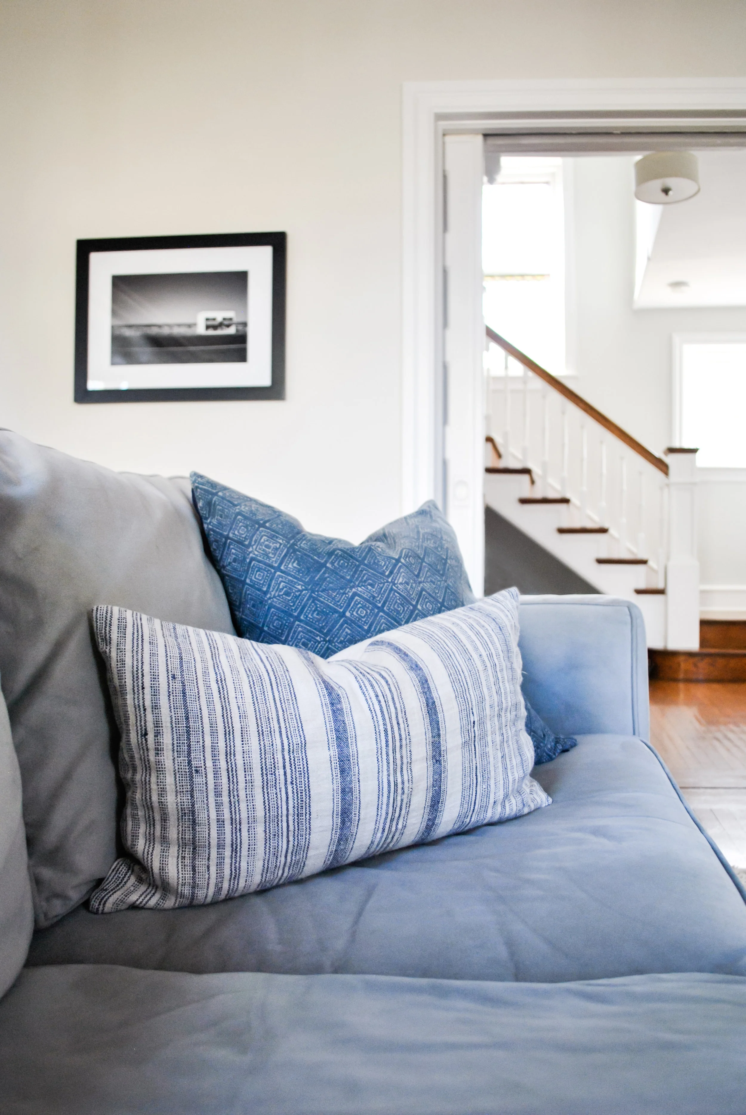 Vintage pillows on this family room sofa in historic Philadelphia home designed by Sharp + Grey Interiors