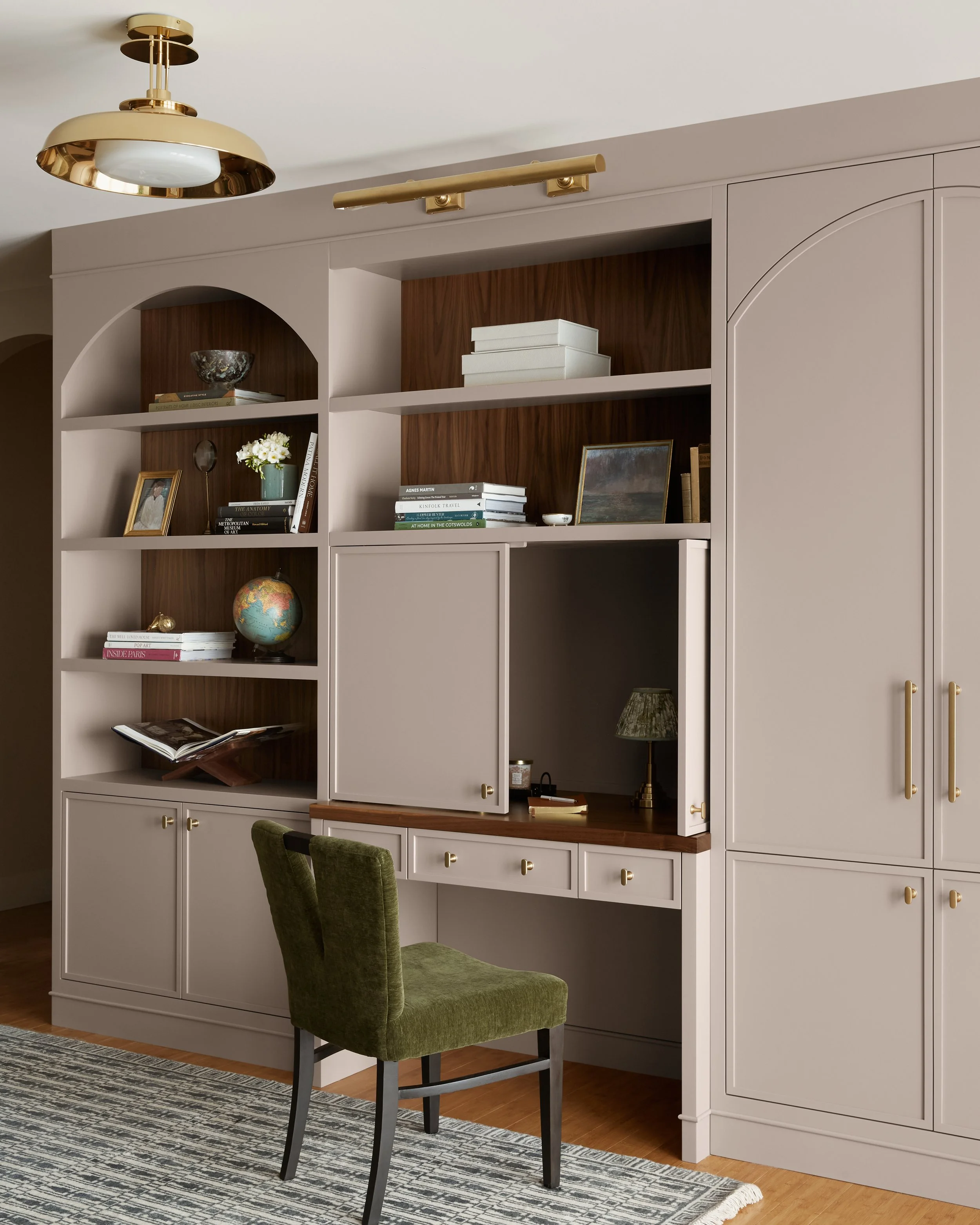 Custom cabinetry in a beautiful Moorestown, New Jersey home. A built-in desk/cabinet design with storage and shelving. A muted paint color pairs perfectly with a walnut wood finish.