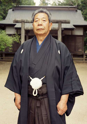 Morihiro Saito Shihan, O-Sensei's chosen successor of the Iwama dojo standing in front of the Aiki Shrine
