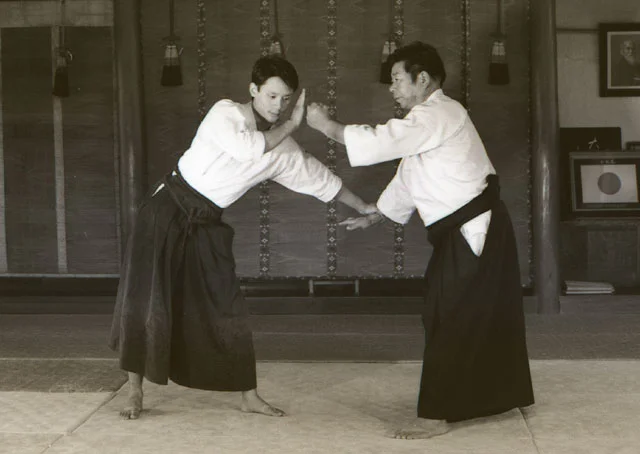 A young Jason blocks an atemi from Saito Sensei at the Iwama dojo. This photo was part of a technical series for the Aikido Journal magazine.