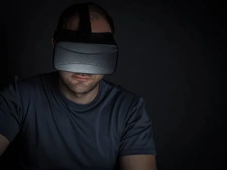65044028-technology-addicted-man-at-home-at-night-using-virtual-reality-headset-technology-addiction-concept-.jpg