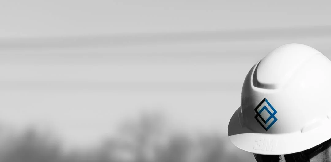 Construction safety helmet with Mac Street Development logo on front