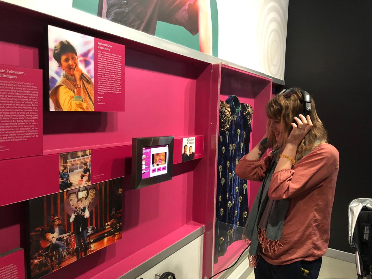 Laura listening at museum.jpeg