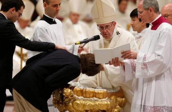 Pope Francis conducting an adult baptism