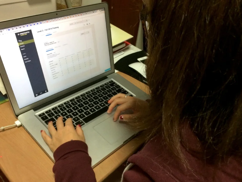 One of the Scholar Tree teacher is testing out a prototype on classroom grade book.