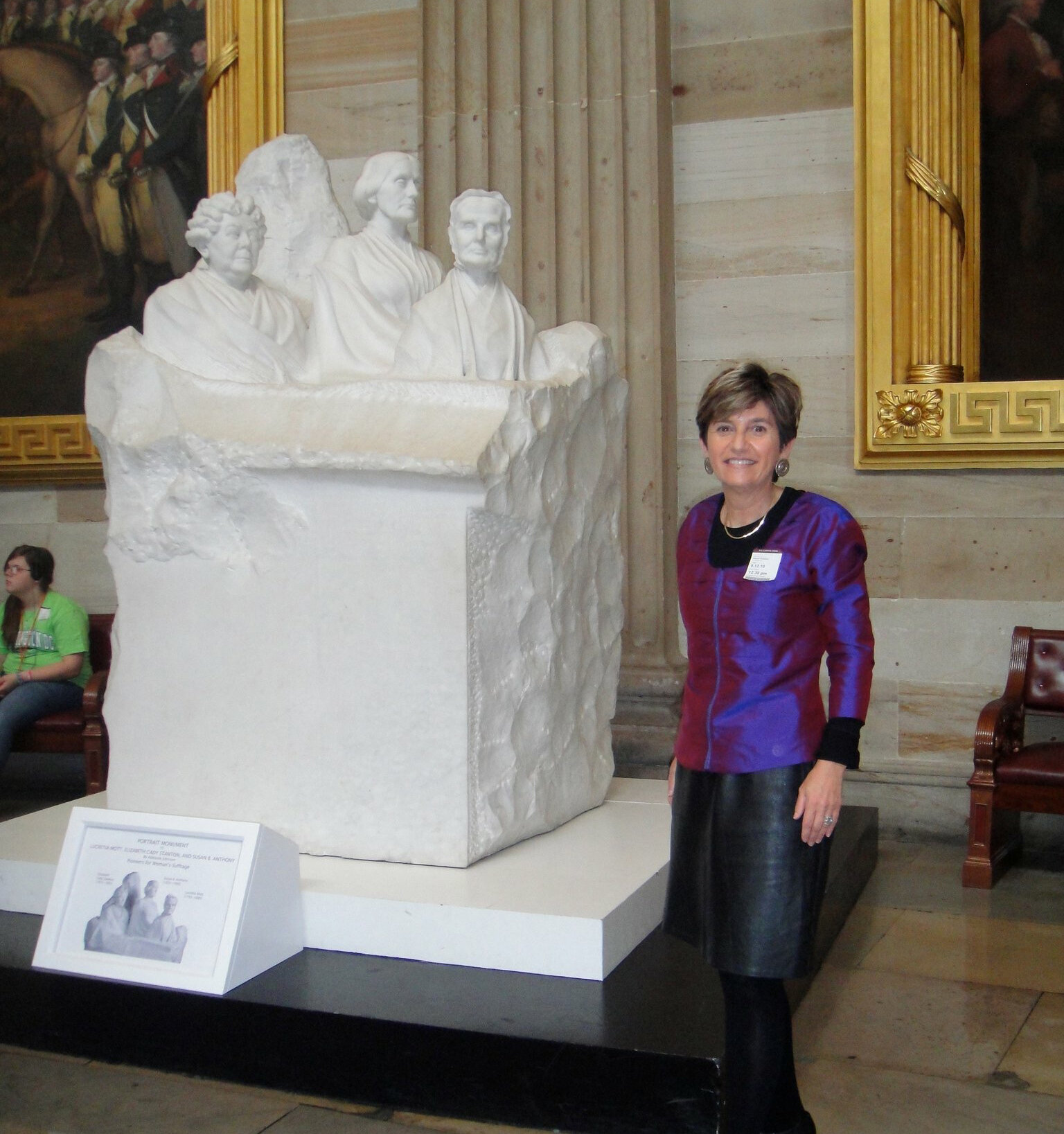 Kathryn Anthony with the group portrait monument to the pioneers of the woman suffrage movement at the US Capitol.