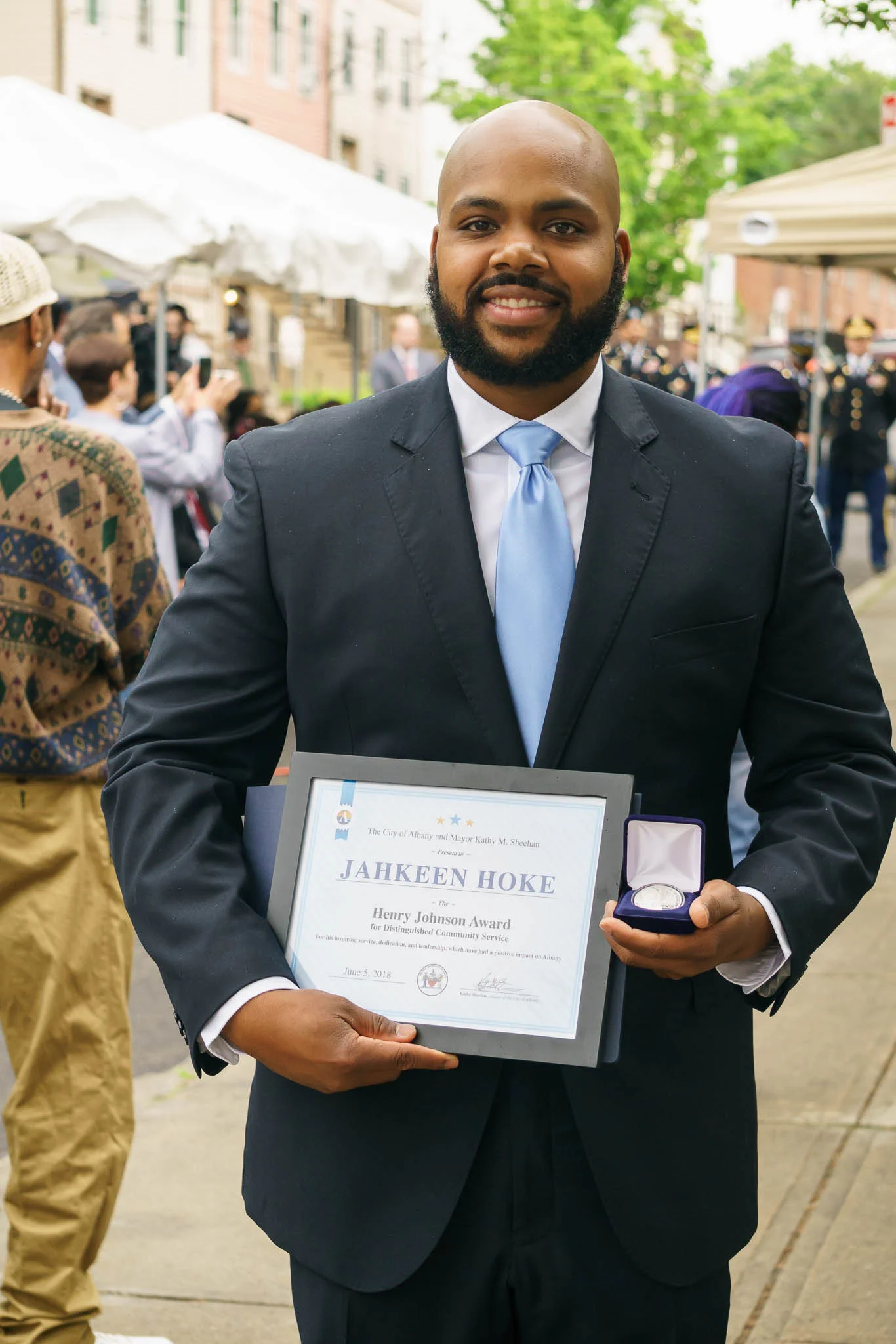 Jahkeen Hoke, winner of the second annual Henry Johnson Award for Distinguished Community Service (holding test strike for Sgt. Henry Johnson silver commemorative).