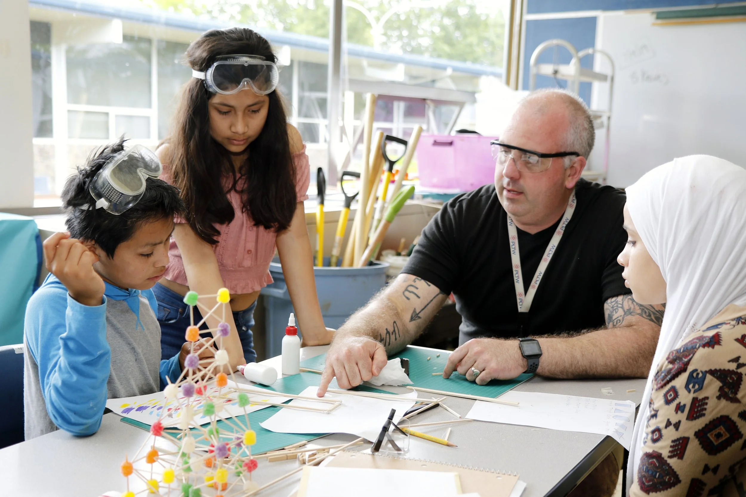 Students and teacher reviewing plans.jpg