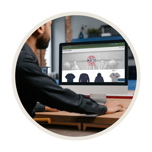 Person managing a custom online apparel store for a business on a computer screen.