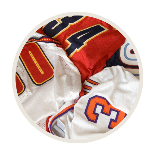 Close-up of high-quality heat transfer vinyl and DTF numbering on athletic jerseys.