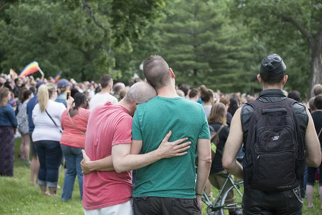 " A Couple at a Vigil to Unite in the Wake of the Orlando Pulse Shooting " by Fibonacci Blue is a Creative Commons image, licensed under CC BY 2.0