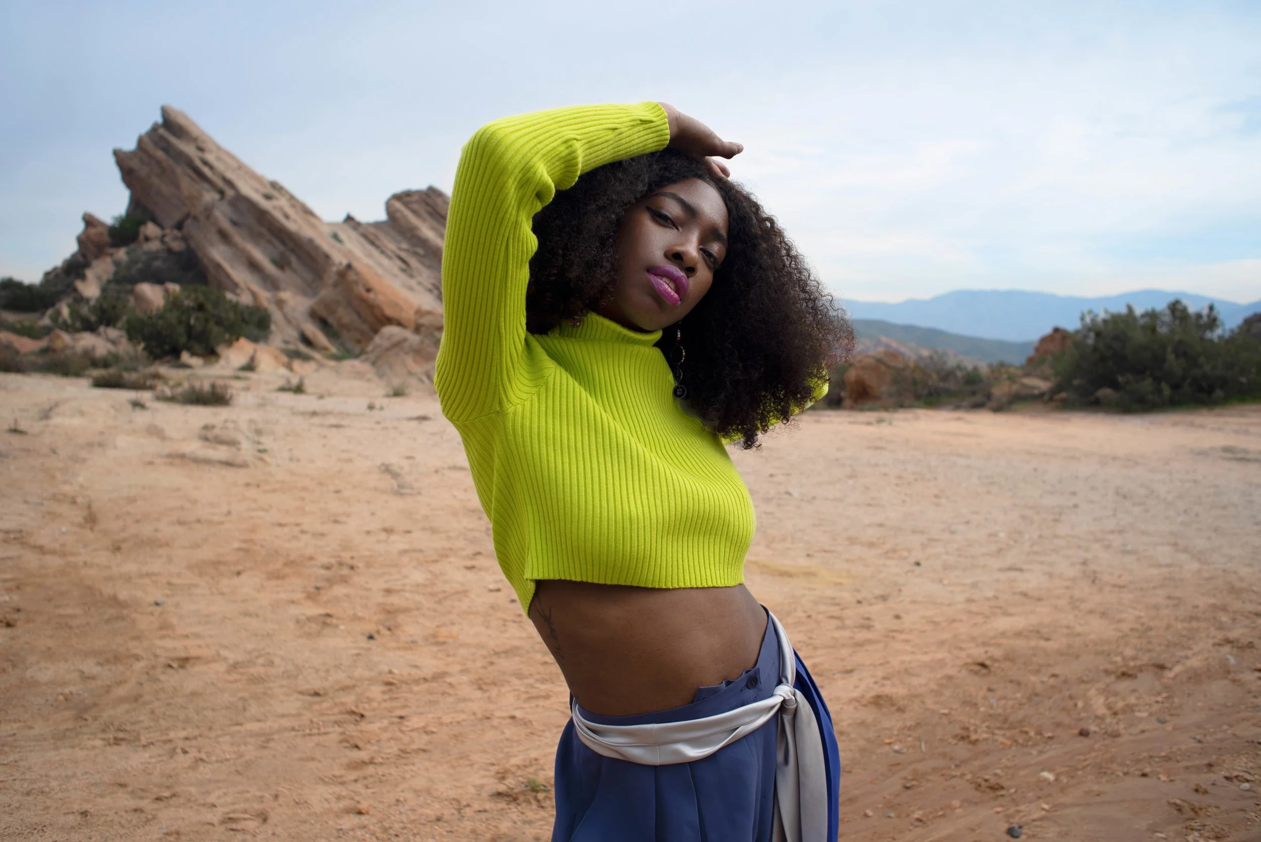   Team Credits   Photography: Graeme Aegerter  Model: Yolanda Redd  Creative Direction: T’keyah Bennett  Stylist: T’keyah Bennett  Assistant Stylist: Nandi George  Hair/Makeup: Yolanda Redd     Clothing Credits   Ribbed Cropped Turtleneck - Red Light