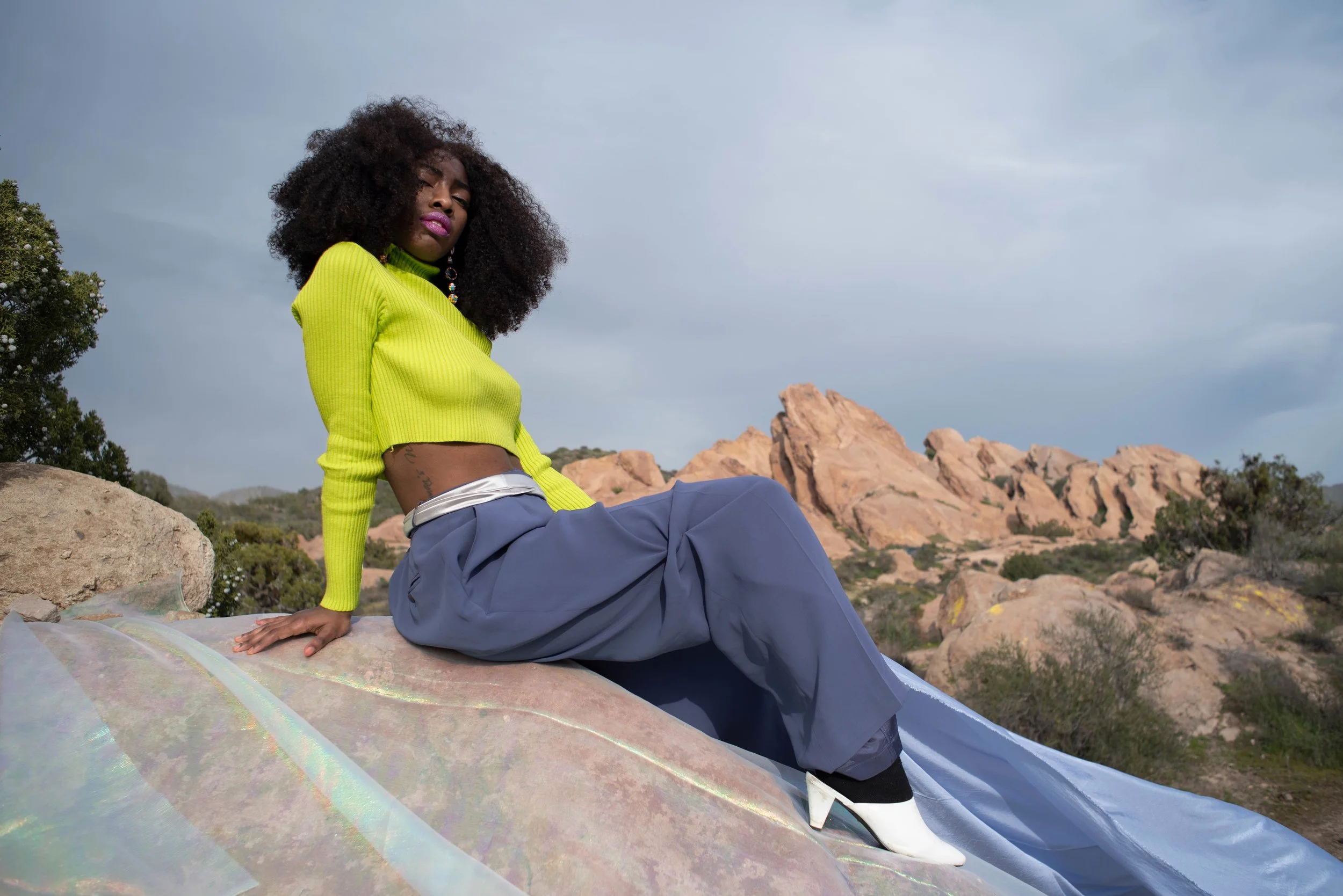   Team Credits   Photography: Graeme Aegerter  Model: Yolanda Redd  Creative Direction: T’keyah Bennett  Stylist: T’keyah Bennett  Assistant Stylist: Nandi George  Hair/Makeup: Yolanda Redd     Clothing Credits   Ribbed Cropped Turtleneck - Red Light