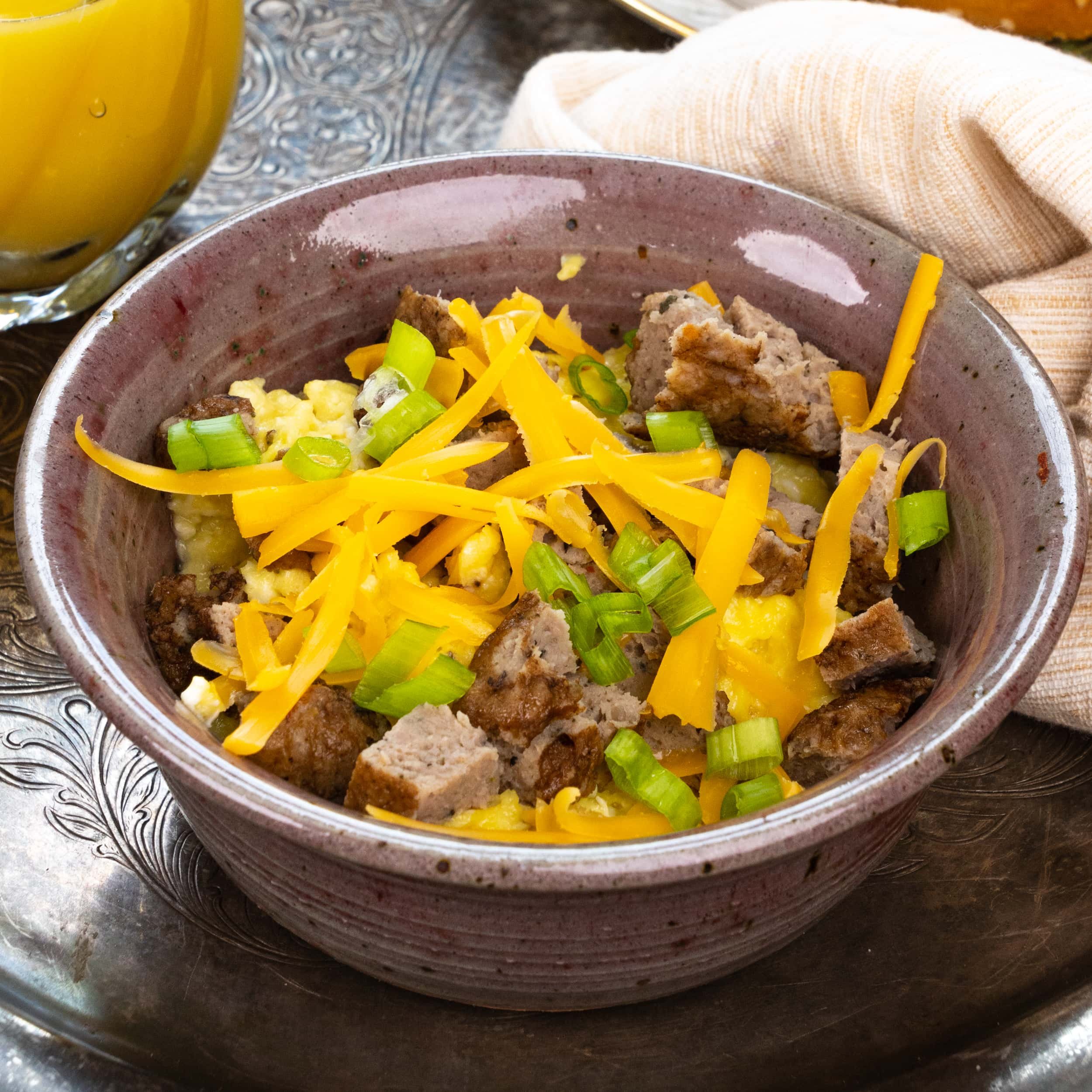 Local Stone Ground Grits Bowl, Country Breakfast Sausage, Scrambled Egg, Cheddar Cheese, Scallions