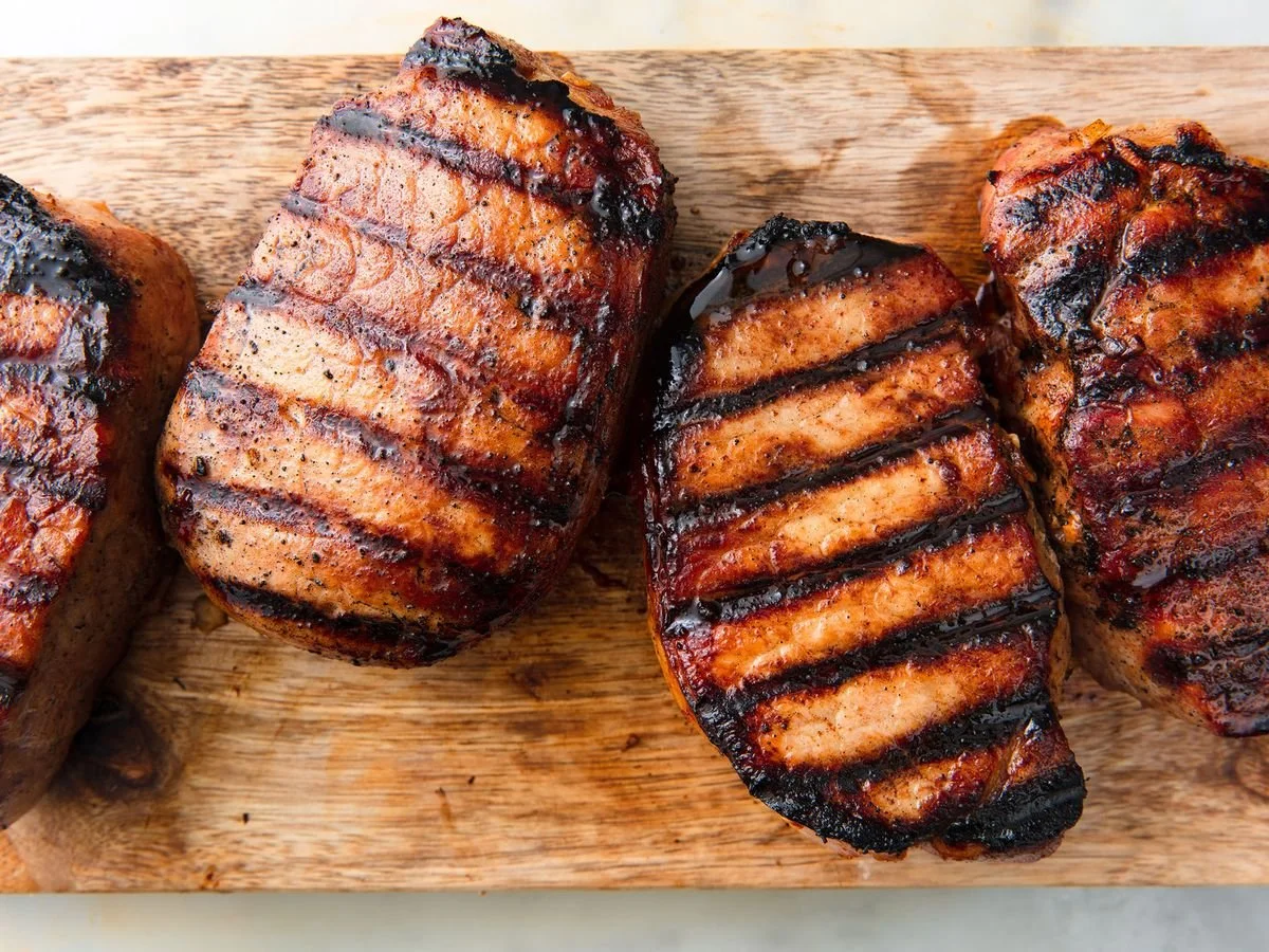 Citrus Marinated Grilled Pork Loin, Blackberry Compote,  Local Stone Ground Yellow Grits, Roasted Broccoli & Cauliflower Florets