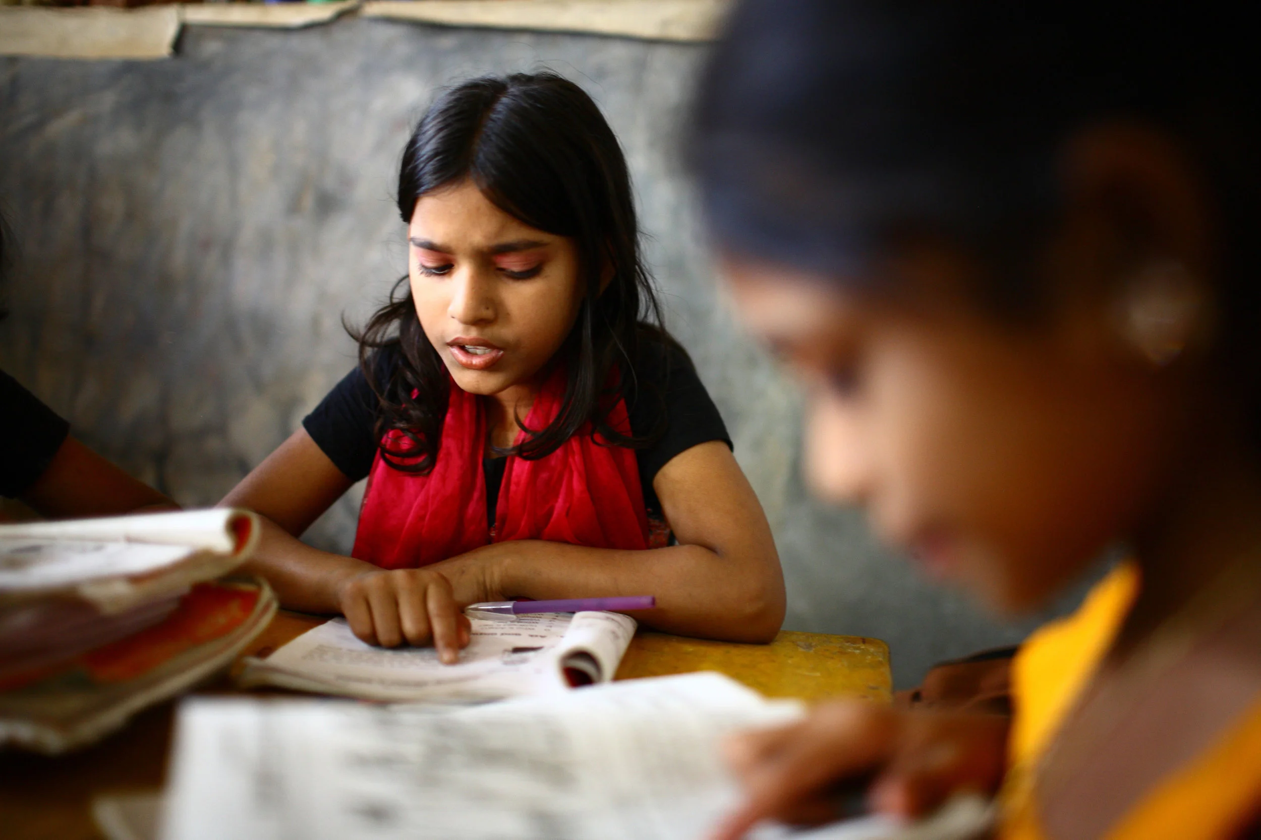 10_years_old_Dipa_and_12_years_old_Laboni_study_in_class_2_at__Unique_Child_learning_Center_,_Mirmur-Dhaka,_Bangladesh.jpg