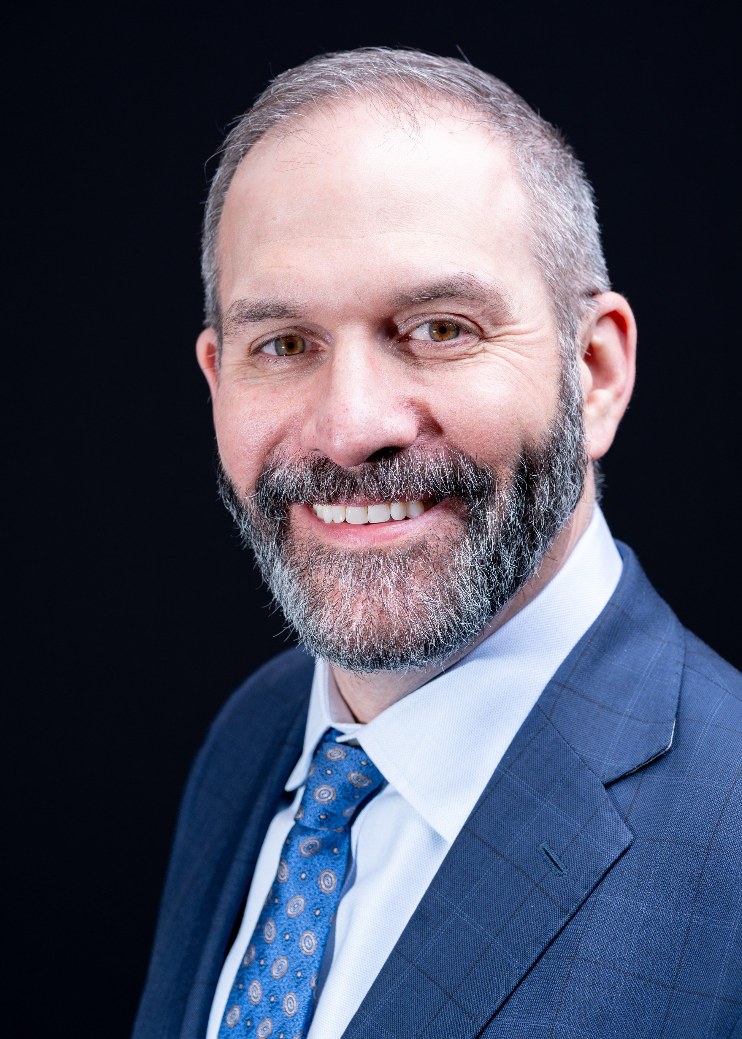 A legal professional standing tall for his professional headshots at Western Connecticut State University for a panel event in Danbury, CT.