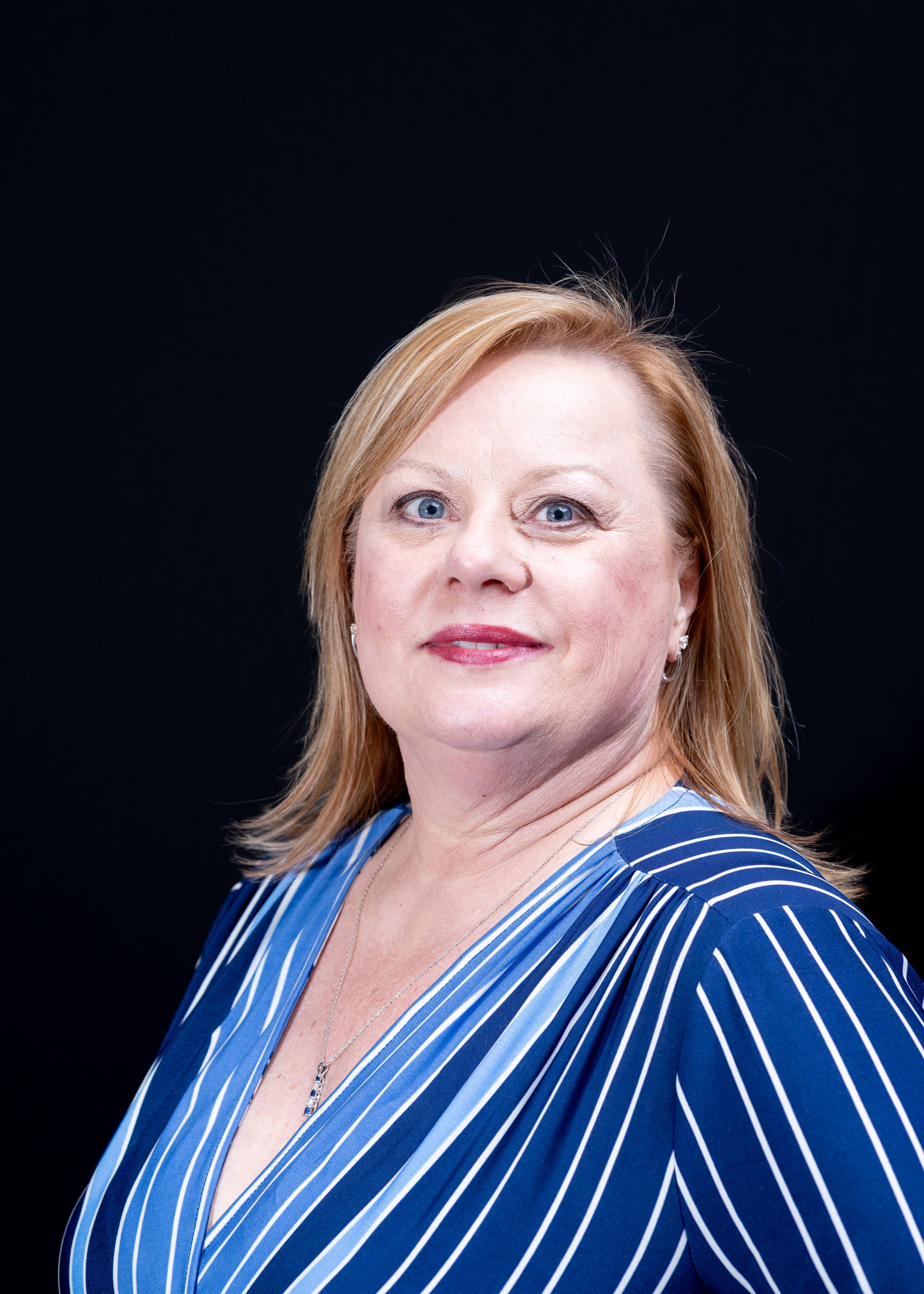 Headshots at Western Connecticut State University, for a panel event "Analysis in Action". A professional woman standing tall for her business profile headshots.